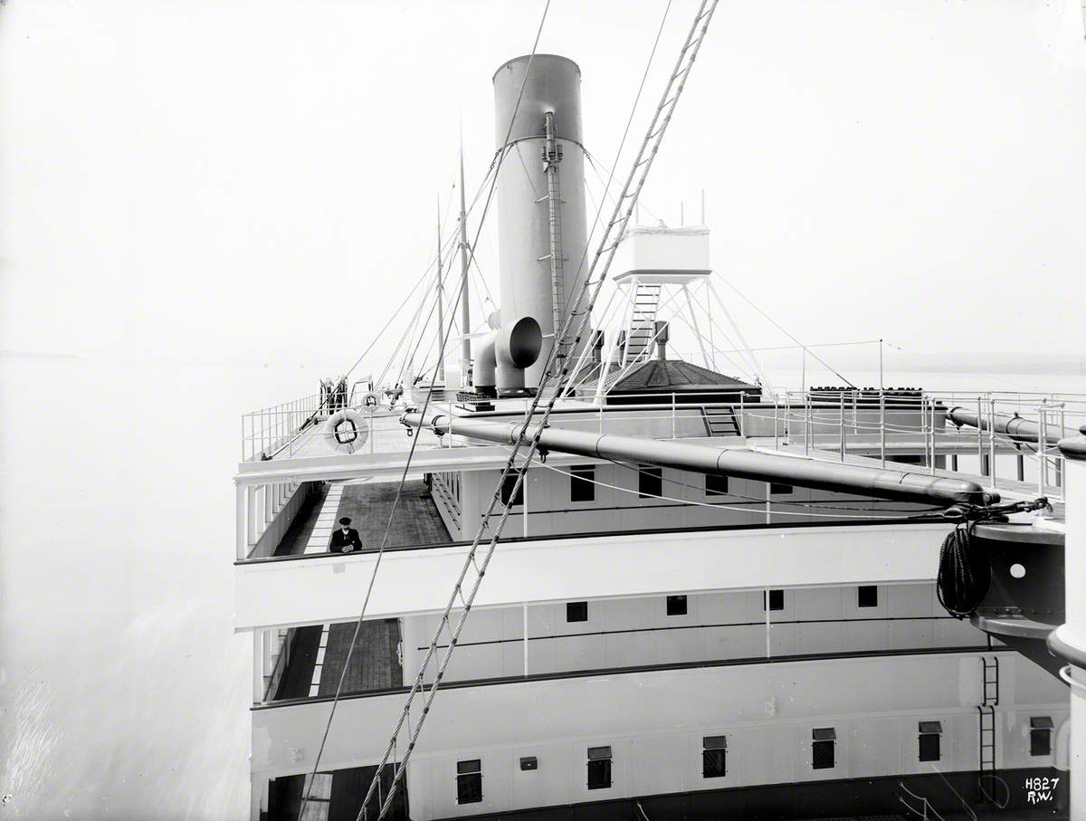 View aft from bridge to passenger superstructure, promenade decks and funnel while at sea