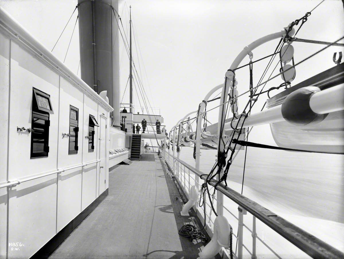 View forward along starboard boat deck towards bridge, while at sea