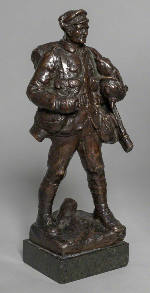 Soldier Carrying a German Helmet