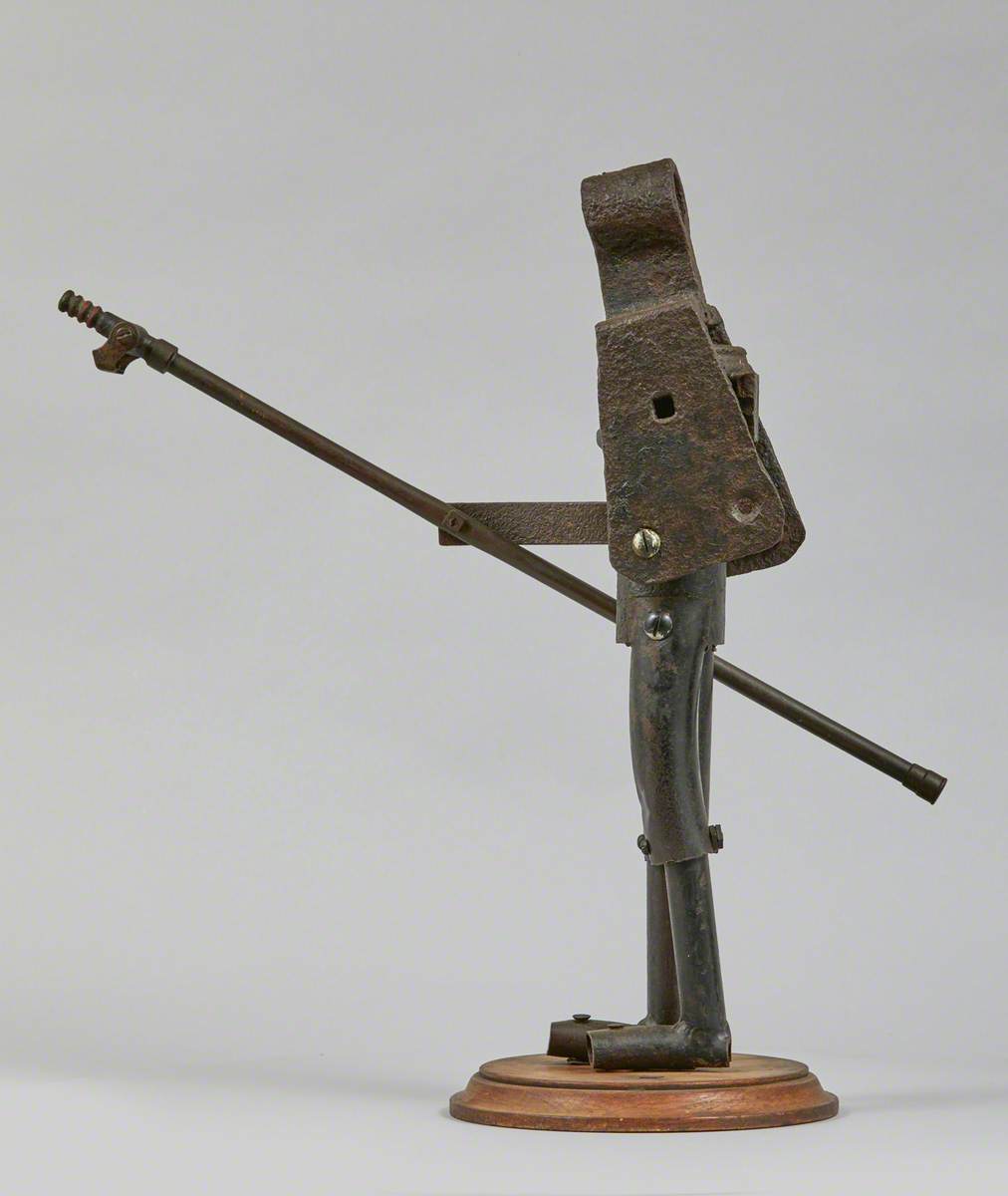 Metal Junk Sculpture: Person with Long Implement in Hand