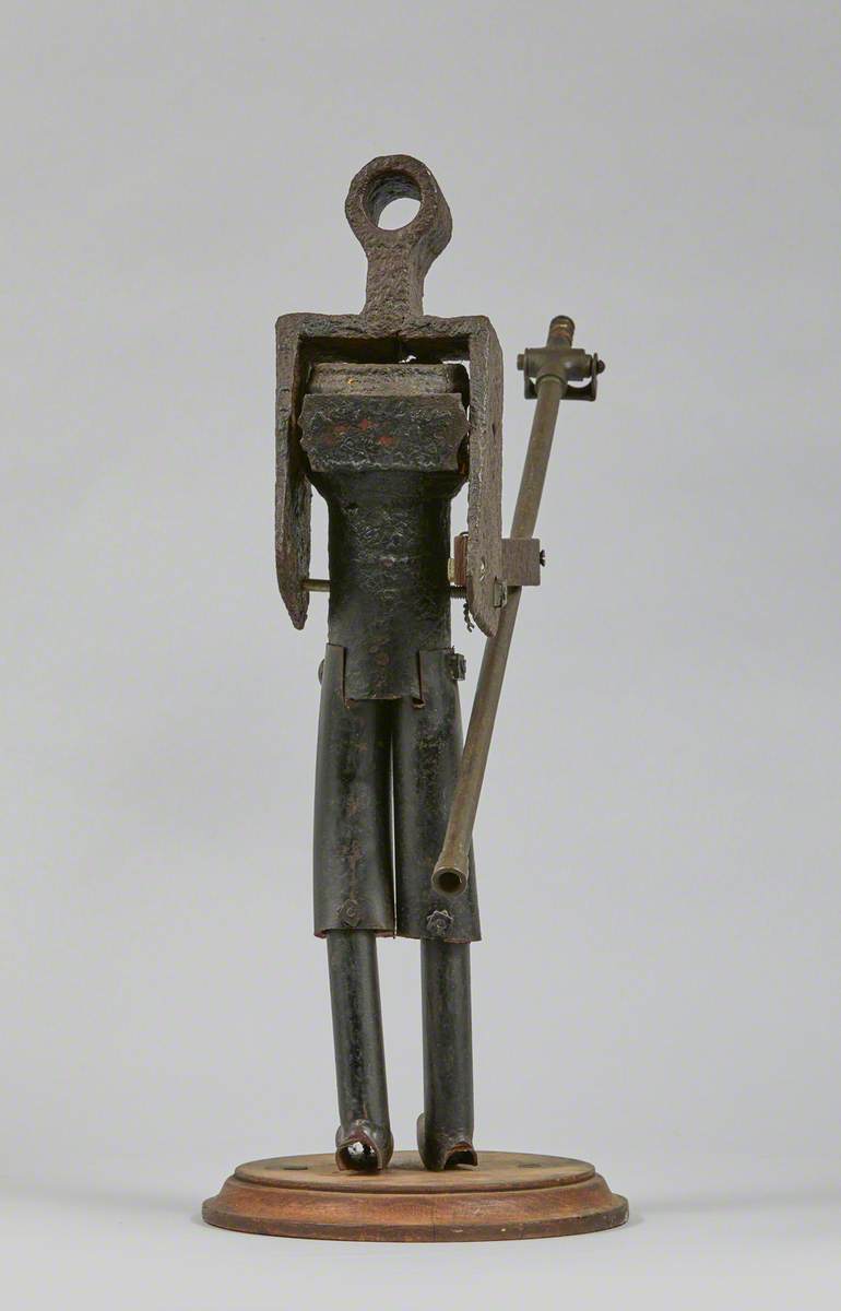 Metal Junk Sculpture: Person with Long Implement in Hand