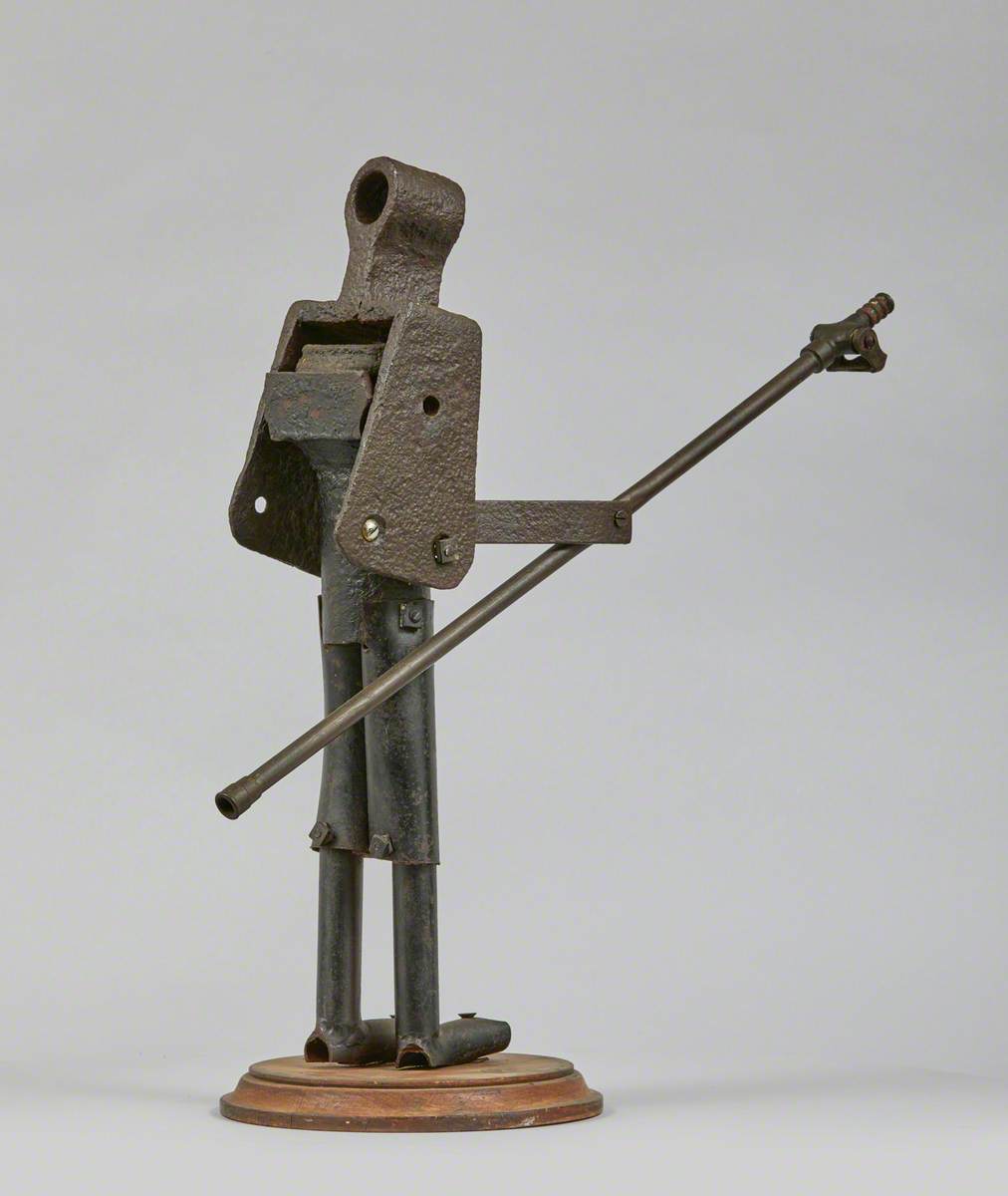 Metal Junk Sculpture: Person with Long Implement in Hand