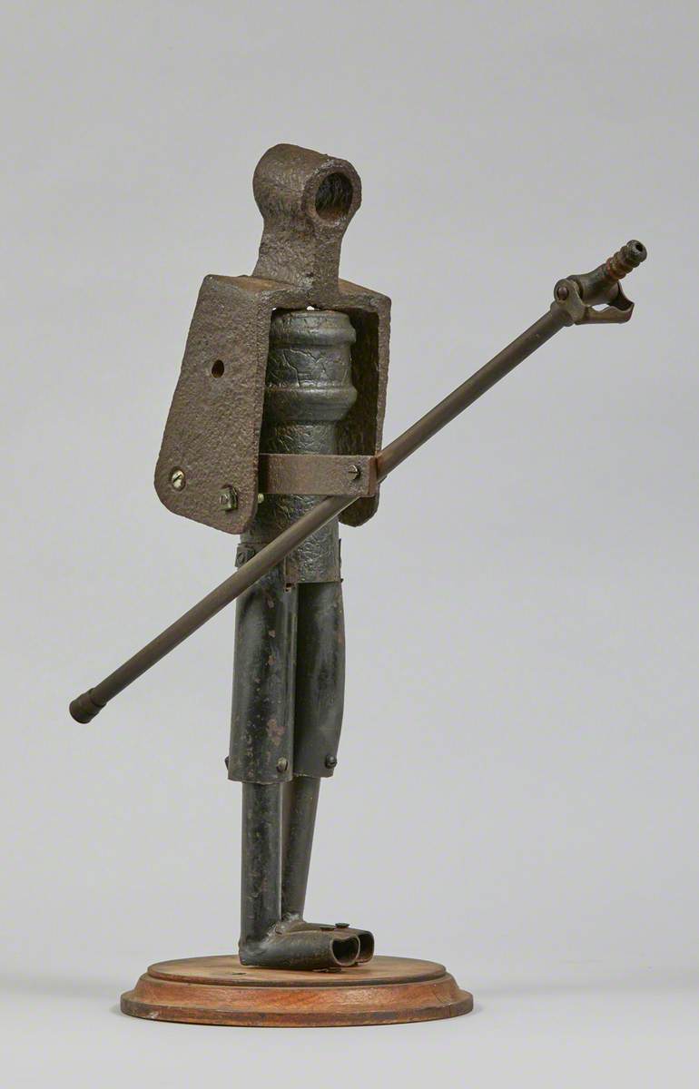 Metal Junk Sculpture: Person with Long Implement in Hand