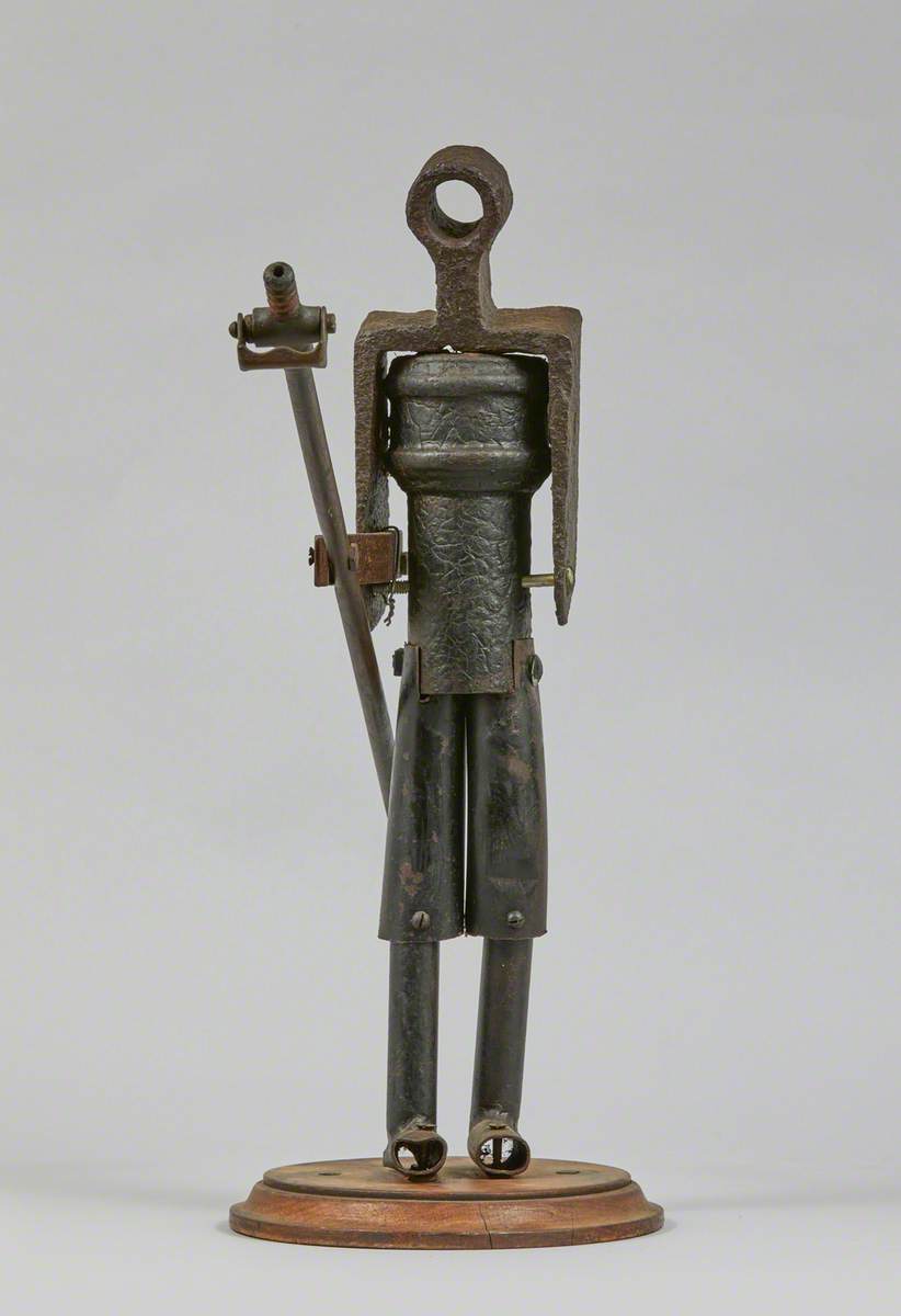 Metal Junk Sculpture: Person with Long Implement in Hand