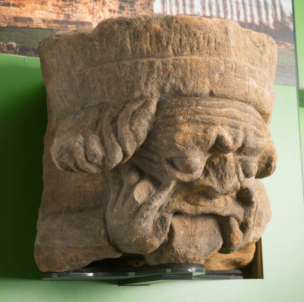 Sandstone Corbel Carved with Human Head with Fingers in the Corners of Mouth: Monk Bretton Priory