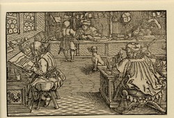 Two men sitting at a table writing