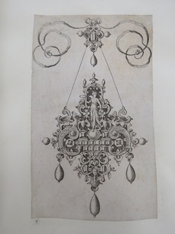 Pendant design with Victory holding a laurel wreath standing on a ball surrounded by grotesque strapwork and inset gems with jewelled ribbon design above, from Douce Ornament Prints Album I