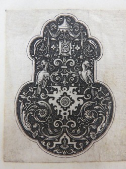 Pendant with two eagles holding sprigs of foliage in beaks seated on rinceaux foliage scrolls extending from strapwork elements on a black ground, from Douce Ornament Prints Album I