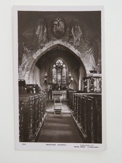St Mary's Church, Mortehoe: photograph of interior showing chancel-arch mosaic and archangel window, both designed by Image