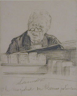 Head of a man in spectacles looking up from an open book