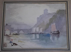 Man sitting by the dock in a bay, with sailing boats and a bridge
