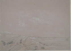 View of sand dunes with a distant town across a bay