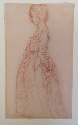 A young girl standing in profile facing left