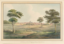View of the Village of Islip, Oxfordshire, seen across meadows, with church tower at centre, framed by trees