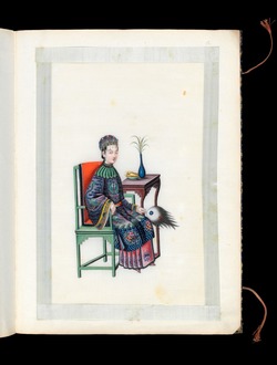 Woman seated with a fan