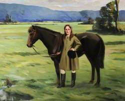 A Girl Holding a Brown Pony in a Field