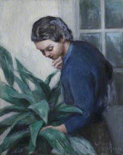 Lady in a Blue Shirt Tending a Plant