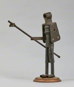 Metal Junk Sculpture: Person with Long Implement in Hand