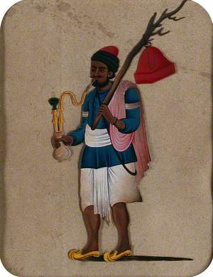 A Man Smoking a Hookah Pipe and Holding a Branch with a Red Object Hanging from It