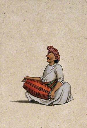 A Musician Playing the Dholak (Double-Sided Drum)