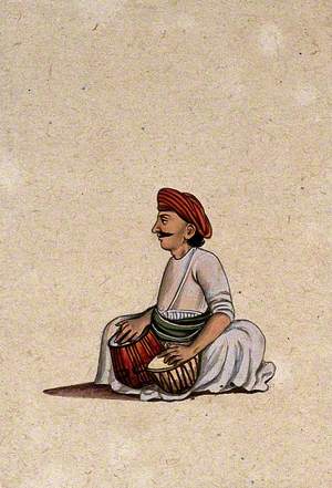 A Musician Playing a Tabla (a Pair of Drums)