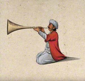 An Indian Musician Playing a Brass Wind Instrument