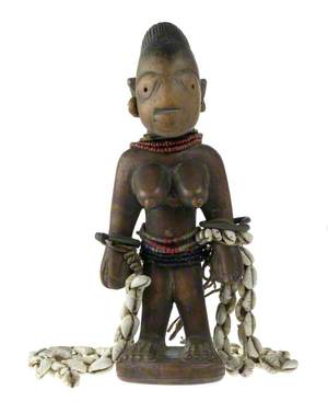 Female of a Pair of Ibeji (Twin) Figures with Cowrie Strings*