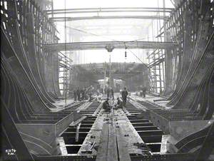 Men working on internal construction of hull, showing tank subdivison