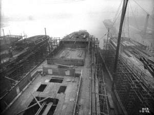 Overhead view from gantry crane aft of midships. Also view of ships 322 and 323