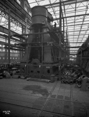Engine seen from ground level, with workmen