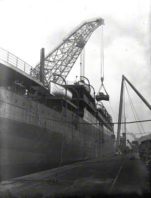 Engine bed and funnel being lifted on board by combination of folating crane and sheer legs