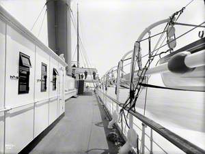 View forward along starboard boat deck towards bridge, while at sea