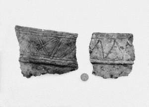 Untitled (a view of fragment of burial urns, Ballyrainey, Comber, with an old penny for scale)