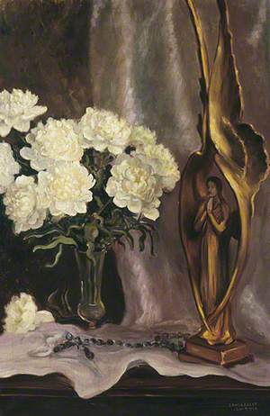 White Flowers in a Vase with a Statue of a Saint and Rosary Beads