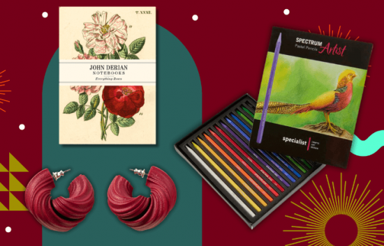 A collection of art gifts including earrings, a notebook and pencils.