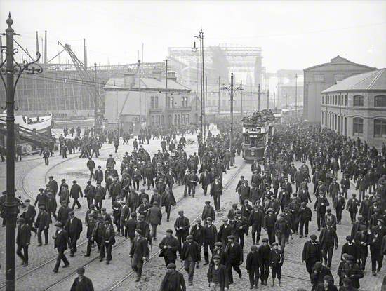 Queen's Road and shipyard men leaving work. 'Titanic' in background ready for launching