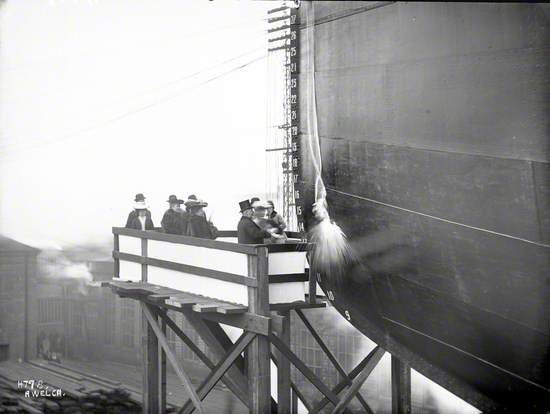 Launch party on platform, bottle breaking on port bow, No. 7 slip South Yard