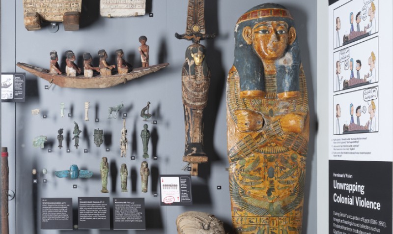 Traditional museum display of ancient Egyptian material, with new labels addressing colonial collecting