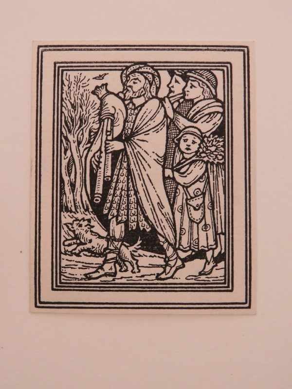 Three figures walking playing instruments (bagpipe and pipes), with a child carrying a Christmas tree, and a dog