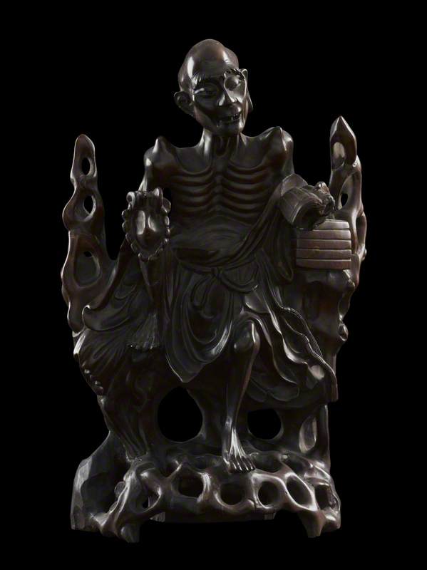 Figure of Moh Chicho reading Buddhist doctrine