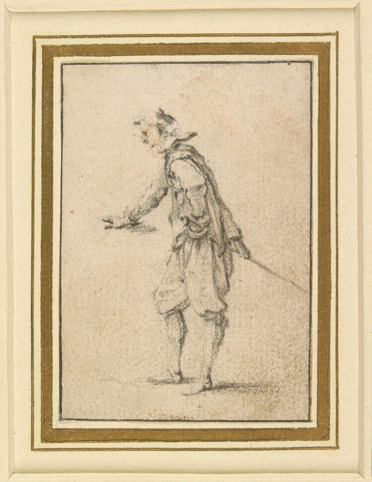 Man holding his right hand forward, as if leaning on a table