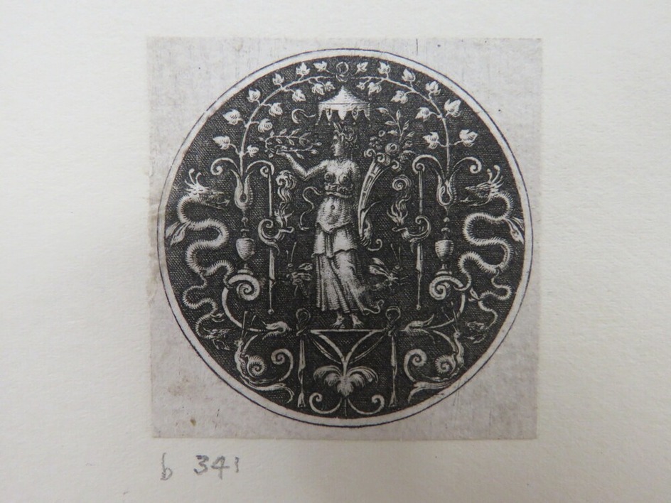 Female at centre holding a laurel crown and a cornucopia under a ivy baldachin, flanked by two grotesque foliate elements with dragons heads, from Douce Ornament Prints Album I