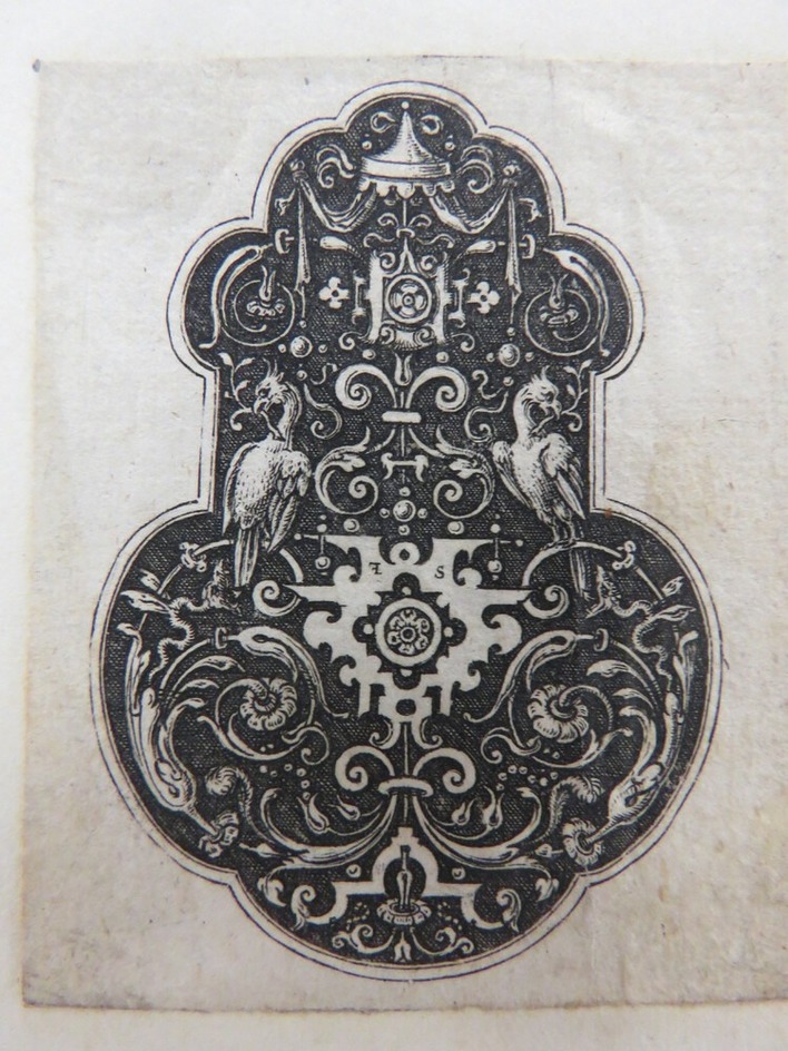 Pendant with two eagles holding sprigs of foliage in beaks seated on rinceaux foliage scrolls extending from strapwork elements on a black ground, from Douce Ornament Prints Album I