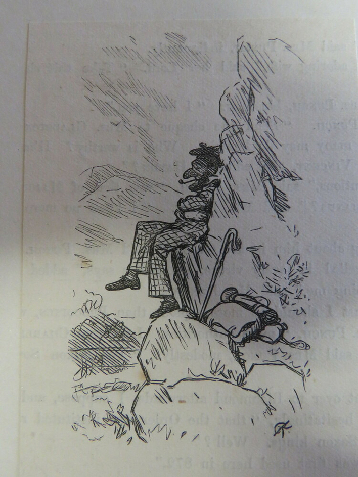 Man sat on rocks with a walking stick and pack nearby