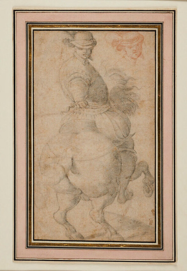 Man on horseback, observed from behind