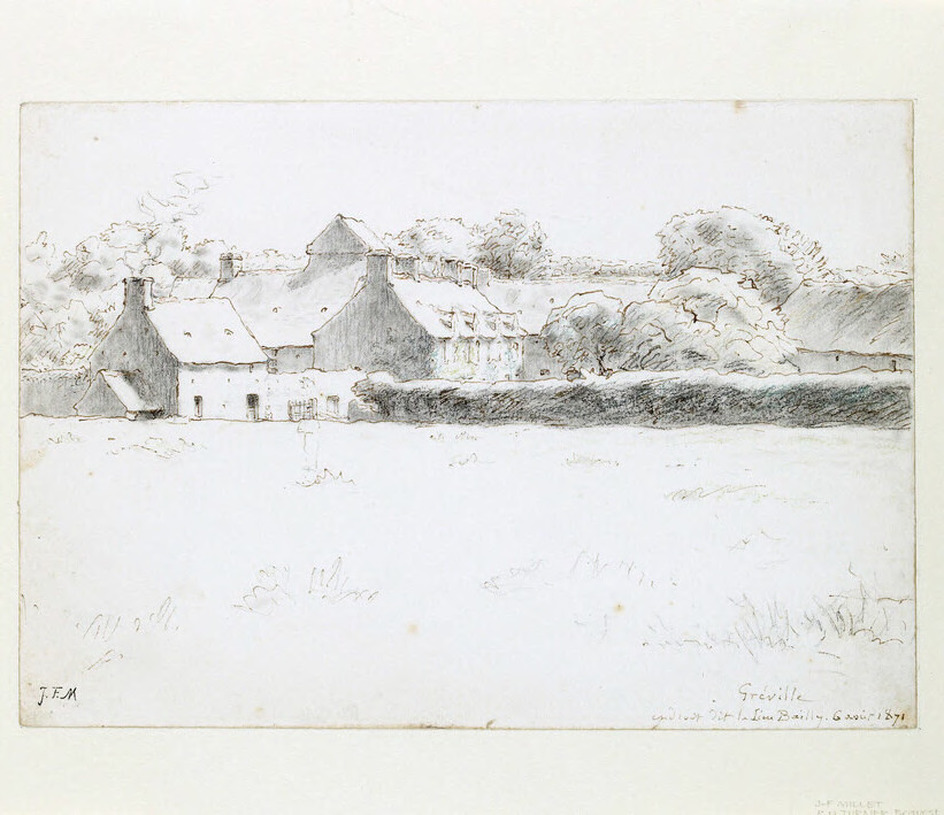 View of farm buildings across a field