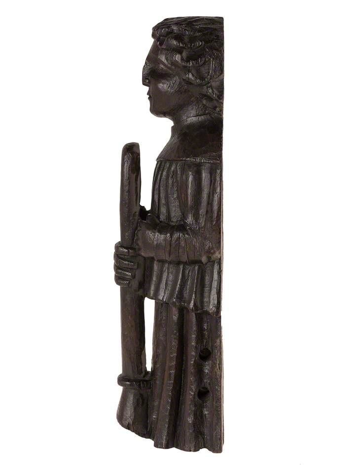 Figure Holding a Wind Instrument*